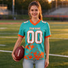 Custom Aqua - White - Orange Graphic Splash Pattern Football Jersey – worn by a woman