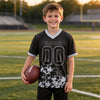 Custom Black - Silver Graphic Splash Pattern Football Jersey – youth size worn by a kid