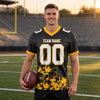 Custom Black - White - Gold Graphic Splash Pattern Football Jersey – worn by a man