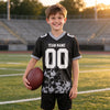 Custom Black - Gray - White Graphic Splash Pattern Football Jersey – youth size worn by a kid