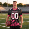 Custom Black - White - Neon Pink Graphic Splash Pattern Football Jersey – worn by a man