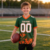 Custom Green - White - Orange Graphic Splash Pattern Football Jersey – youth size worn by a kid
