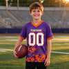 Custom Purple - White - Orange Graphic Splash Pattern Football Jersey – youth size worn by a kid