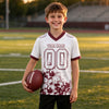 Custom White - Burgundy Graphic Splash Pattern Football Jersey – youth size worn by a kid