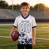 Custom White - Navy Graphic Splash Pattern Football Jersey – youth size worn by a kid