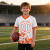 Custom White - Orange Graphic Splash Pattern Football Jersey – youth size worn by a kid