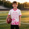 Custom White - Pink Graphic Splash Pattern Football Jersey – youth size worn by a kid