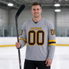 Custom Gray - Gold - Brown Triple Stripes Hockey Jersey – worn by a man