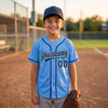 Custom Piped Baseball Jersey – Light Blue Navy Blue Teal – youth size worn by a kid