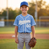 Custom Piped Baseball Jersey – Light Blue White Gray – youth size worn by a kid
