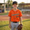 Custom Orange - Black - Cream - Old Gold Piped Baseball Jersey – youth size worn by a kid