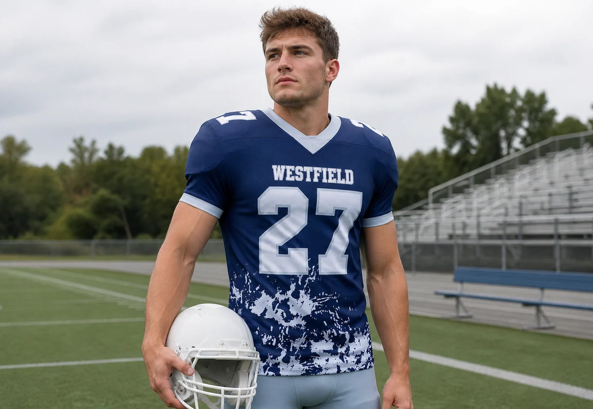 Football player wearing a personalized navy short-sleeve jersey on the sideline