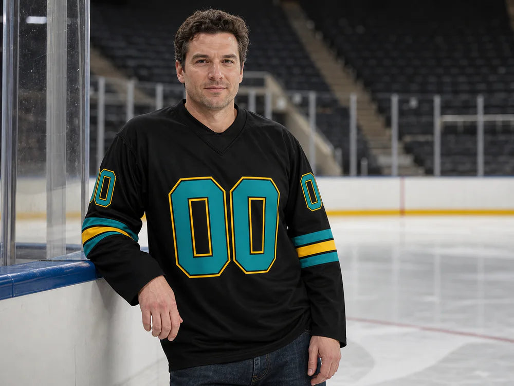 Person wearing a black, teal and yellow long-sleeve personalized jersey